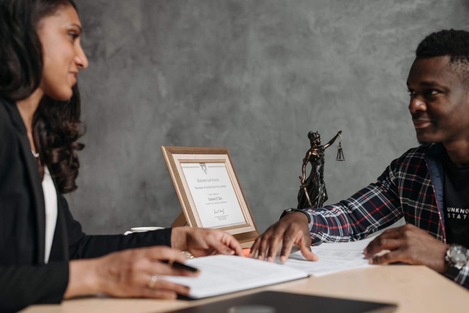 A woman and a man review documents together at a desk
