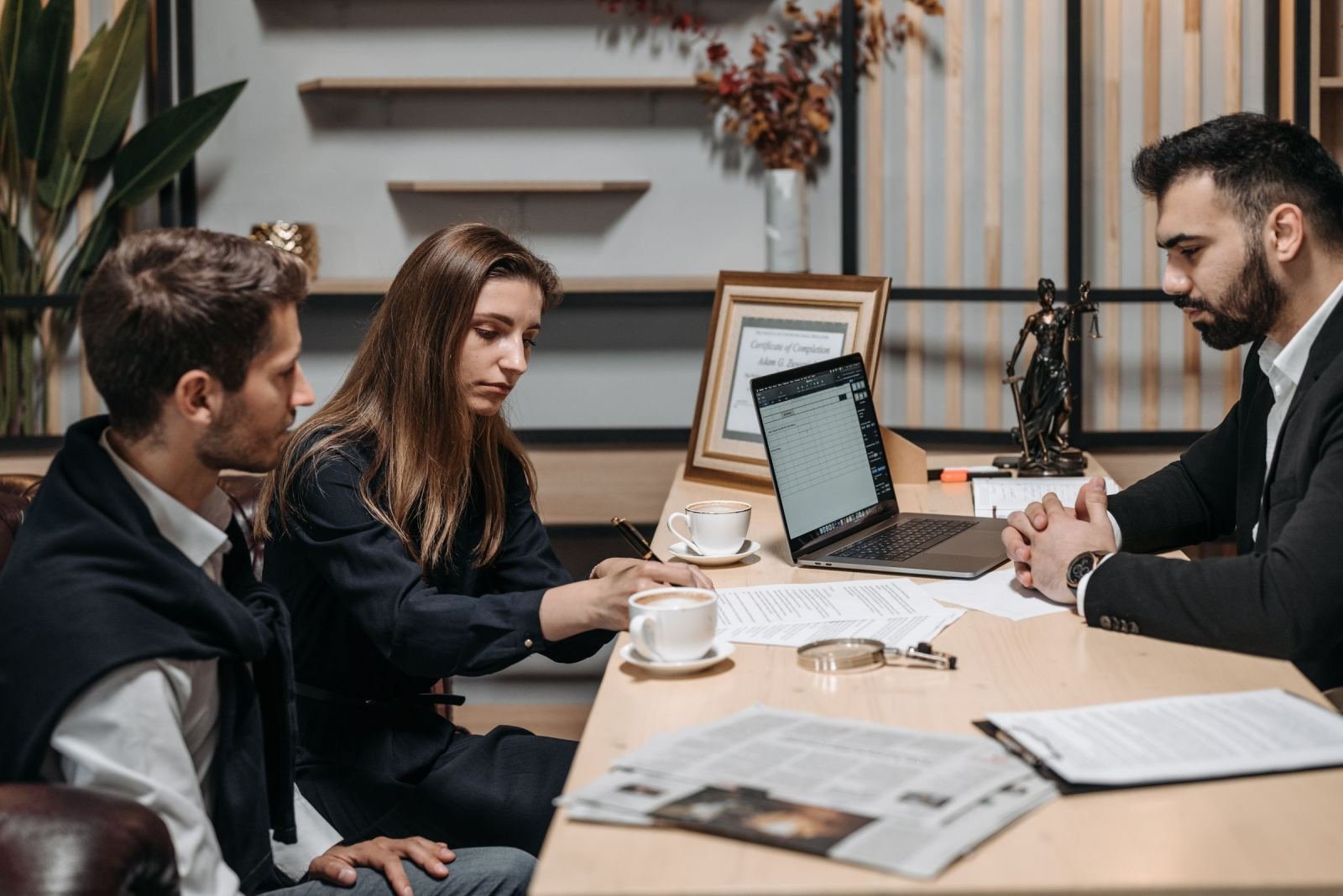 Two people talk with a pro in a well-lit room about their choices.