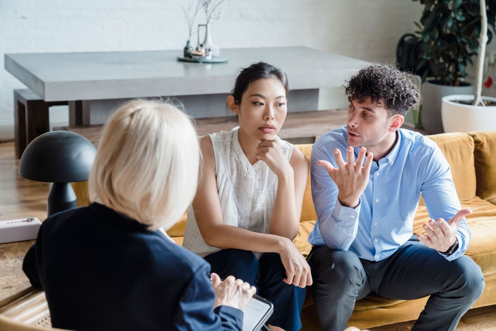 A couple talks with a counselor in a modern office