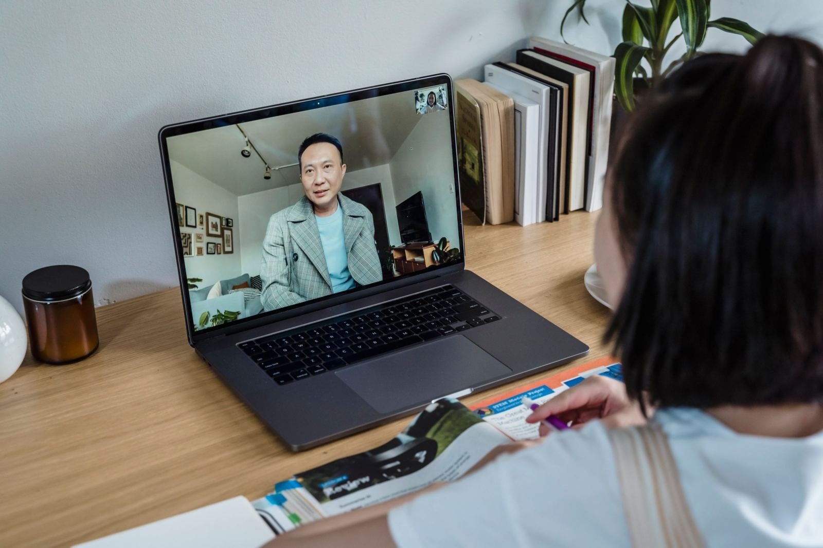 A person on a video call with a healthcare provider on a laptop screen